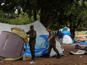 Members of the military take down tents at a camp left by supporters of Brazil's former President Jair Bolsonaro, outside the Army Headquarters in Brasilia, Brazil, Jan. 9, 2023.