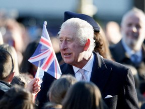 King Charles greets people as he arrives to visit the Bolton Town Hall, in Bolton, Britain, Jan. 20, 2023.