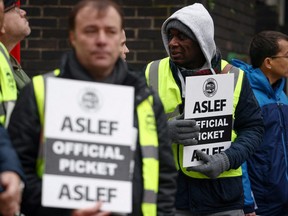 Rail workers that are members of the ASLEF union stand at a picket line outside Euston station while on strike, in London, Jan. 5, 2023.