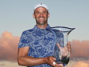 Canadian Ben Silverman poses with the trophy after winning the Bahamas Great Abaco Classic in a playoff yesterday at The Abaco Club.