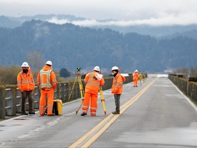 In this file photo taken on Dec. 20, 2022, CalTrans workers assess damage to a bridge after a strong 6.4-magnitude earthquake struck off the coast of northern California, in Rio Dell, Calif.