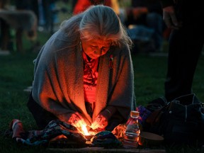 A woman prepares for sunrise ceremony, attended by Prime Minister Justin Trudeau to mark the National Day for Truth and Reconciliation, honouring the lost children and survivors of Indigenous residential schools, at Niagara Parks power station, Ont., Sept. 30, 2022.