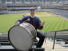 Cleveland Indians fan John Adams poses in his usual centrefield bleacher seat with his ever-present bass drum before a baseball game between the Indians and the Kansas City Royals on April 27, 2011, in Cleveland.