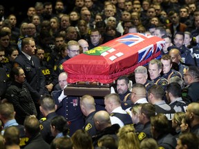 Pallbearers carry the casket of OPP Const. Grzegorz (Greg) Pierzchala during his funeral service in Barrie, Ont., Wednesday, Jan.4, 2023. THE CANADIAN PRESS/Frank Gunn