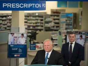 Ontario Premier Doug Ford listens to a question from a reporter following a press conference at a Shoppers Drug Mart pharmacy in Etobicoke, Ont., on Wednesday, Jan. 11, 2023.