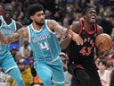 Raptors' Pascal Siakam (right) battles Charlotte Hornets' Nick Richards during the first half in Toronto on Thursday, Jan. 12, 2023.