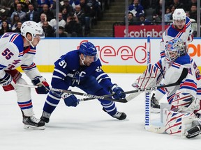 New York Rangers goaltender Igor Shesterkin makes a save on Maple Leafs' John Tavares as Rangers' Ryan Lindgren defends during the second period in Toronto on Wednesday, Jan. 25, 2023.