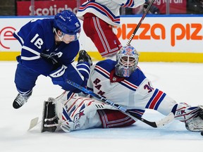 Maple Leafs' Mitch Marner scores the overtime winning goal against New York Rangers goaltender Igor Shesterkin in Toronto on Wednesday, Jan. 25, 2023.