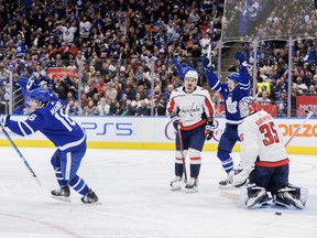 Maple Leafs' Mitch Marner (left) and Michael Bunting celebrate a goal by teammate Morgan Rielly, not shown, as Washington Capitals goaltender Darcy Kuemper looks on during the second period in Toronto on Sunday, Jan. 29, 2023.