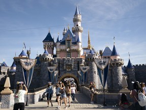 Visitors exit The Sleeping Beauty Castle at Disneyland in Anaheim, Calif.