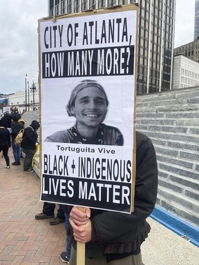 A demonstrator holds a sign protesting the death of an environmental activist, who went by Tortuguita, in Atlanta on Saturday, Jan. 21, 2023.