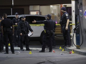 Oakland police investigate a multiple shooting and homicide at the Valero gas station on Seminary Avenue at MacArthur Boulevard in Oakland, Calif., on Monday, Jan. 23, 2023.
