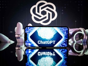 This picture taken on January 23, 2023 in Toulouse, France, shows screens displaying the logos of OpenAI and ChatGPT.