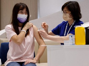 Yoyo Liang, from mainland China, received a dose of BioNTech bivalent COVID-19 vaccine at a private clinic in Hong Kong, Thursday, Jan. 12, 2023.