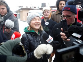 Climate activist Greta Thunberg reacts as she walks with members of the media during the World Economic Forum in Davos, Switzerland January 19, 2023.