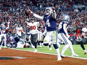 TAMPA, FLORIDA - JANUARY 16: Dak Prescott #4 of the Dallas Cowboys rushes for a touchdown against the Tampa Bay Buccaneers during the second quarter in the NFC Wild Card playoff game at Raymond James Stadium on January 16, 2023 in Tampa, Florida. (Photo by Mike Ehrmann/Getty Images)