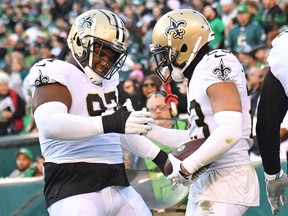 New Orleans Saints cornerback Marshon Lattimore, right, celebrates his interception return for a touchdown with defensive end Malcolm Roach during the fourth quarter against the Philadelphia Eagles at Lincoln Financial Field in Philadelphia, Jan. 1, 2023.