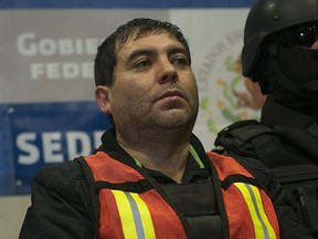 Felipe Cabrera Sarabia, aka "El Inge," is escorted by members of the Mexican army during his presentation for the press in Mexico City on Dec. 26, 2011.