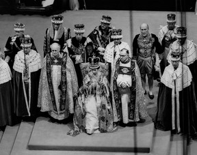 Queen Elizabeth II sits on a throne during her coronation in Westminster Abbey in London on June 2, 1953.