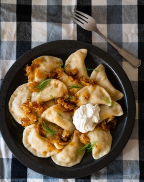 Homemade potato pierogi with fried onion, dill and sour cream – voloshyna/Getty Images