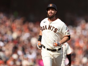 Brandon Belt of the San Francisco Giants rounds the bases after hitting a home run against the Miami Marlins in the eighth inning during their opening day game at Oracle Park on April 08, 2022 in San Francisco, California.