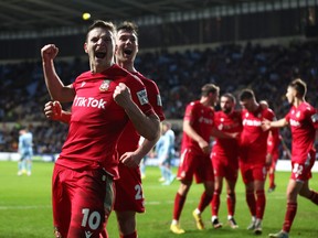 Paul Mullin of Wrexham celebrates after Thomas O'Connor of Wrexham celebrates scores his teams third goal during the Emirates FA Cup Third Round match between Coventry City and Wrexham at The Coventry Building Society Arena on January 07, 2023 in Coventry, England.