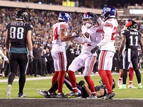 Dane Belton of the New York Giants celebrates with teammates after an interception during the third quarter against the Philadelphia Eagles at Lincoln Financial Field on Jan. 8 in Philadelphia. Our Don Brennan is predicting a Giants upset this weekend.