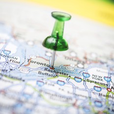 A road map with a push pin in the city of Toronto, Canada.