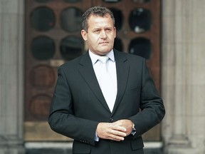 British former butler Paul Burrell poses for the media outside London's High Court, in central London, 14 January 2008, during the inquest into the death of Diana, Princess of Wales. (Photo credit: SHAUN CURRY/AFP via Getty Images)