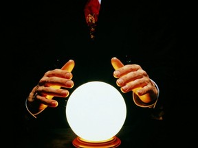 Man in suit with hands around glowing crystal ball