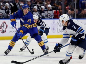Winnipeg Jets center Karson Kuhlman tries to defend as Buffalo Sabres defenseman Owen Power makes a pass during the second period at KeyBank Center.