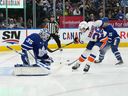 New York Islanders defenseman Alexander Romanov attempts a shot on Toronto Maple Leafs goaltender Ilya Samsonov during the second period at Scotiabank Arena. 