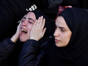 The daughter of 57-year-old teacher Jawad Bouaqneh reacts as mourners carry his and 28-year-old militant Adham Jabbarin bodies during their funeral, in Jenin, in the Israeli-occupied West Bank January 19, 2023.