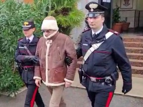 A screengrab taken from a video shows Matteo Messina Denaro the country's most wanted mafia boss being escorted out of a Carabinieri police station after he was arrested in Palermo, Italy, Monday, Jan. 16, 2023.