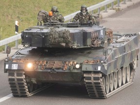 Soldiers of the Swiss Army are seen in a Leopard 2 tank, taking part in a military exercise as they drive on the A1 motorway near Othmarsingen, Switzerland, Nov. 28, 2022.