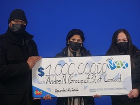 Costco workers Andre Nicholson of Concord, Aileen Mendoza of Toronto and Ponrose (Rose) Antonipillai of Woodbridge with their $1-million Maxmillions prize in the Oct. 11, 2022 Lotto Max draw.