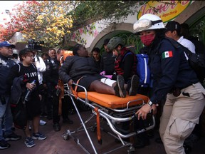 Paramedics assist a woman after two subway trains collide head-on at a subway station, in Mexico City, Mexico, Jan. 7, 2023.