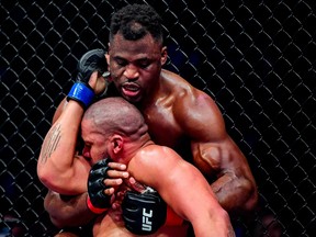 Jan 22, 2022; Anaheim, California, USA; Francis Ngannou (red gloves) competes against Cyril Gane (blue gloves) during UFC 270 at Honda Center.