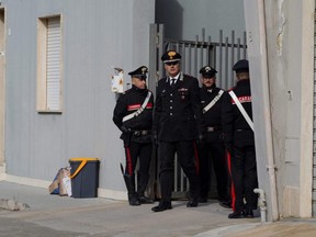 Carabinieri police stand guard near the hideout of Matteo Messina Denaro, Italy's most wanted mafia boss, after he was arrested, in the Sicilian town of Campobello di Mazara, Italy, Tuesday, Jan. 17, 2023.