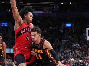 Atlanta Hawks guard Trae Young (11) controls the ball as Toronto Raptors forward Scottie Barnes (4) tries to defend during the second quarter at the Scotiabank Arena against the Toronto Raptors.