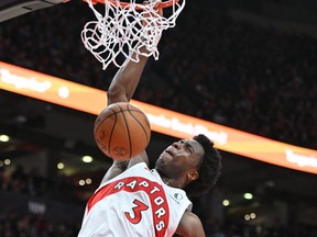 Toronto Raptors forward O.G. Anunoby (3) dunks over Charlotte Hornets center Mason Plumlee (24) in the second half at Scotiabank Arena.