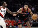Toronto Raptors small forward Scottie Barnes (4) dribbles the ball while defended by Portland Trail Blazers small forward Nassir Little (10) during the second half at Moda Center