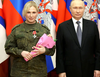 Russian President Vladimir Putin attends a ceremony to award military orders and medals to service members involved in Russia-Ukraine conflict, at the headquarters of the Southern Military District in Rostov-on-Don, Russia December 31, 2022. Observers are trying to figure out who the mystery blond is who appears at numerous Putin photo ops.