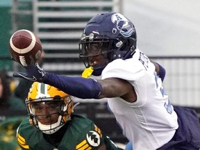 Toronto Argonauts defensive back Jamal Peters (right) and  Edmonton Elks wide receiver Dillion Mitchell battle for the ball during a Canadian Football League game in Edmonton on Oct. 15, 2022.