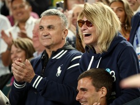 The parents of Novak Djokovic, father Srdjan Djokovic (left) and mother Dijana Djokovic, react after he beats Russia's Andrey Rublev during the Australian Open in Melbourne on January 25, 2023.