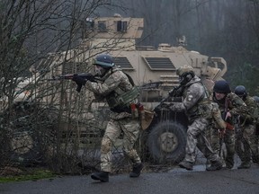 Ukrainian servicemen attend a joint drills of armed forces, national guards, border guards and Security Service of Ukraine (SBU) at the border with Belarus in the abandoned city of Pripyat, Ukraine January 20, 2023.