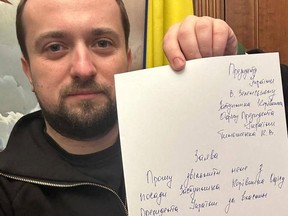 Deputy head of Ukraine's Presidential Office Kyrylo Tymoshenko holds up a note written on a sheet of paper as he tenders his resignation, asking President Volodymyr Zelenskiy to relieve him of his duties, in this picture taken at an unknown location and released on social media on January 24, 2023.