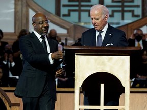 U.S. President Joe Biden stands next to Senator Raphael Warnock (D-GA), a senior pastor at Ebenezer Baptist Church, ahead of the holiday honouring Martin Luther King Jr., in Atlanta, Georgia, January 15, 2023.