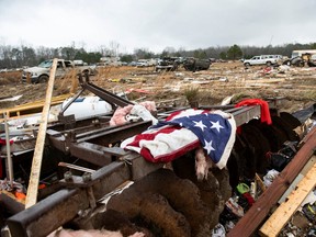 A flag is draped on the remnants of a home destroyed by a tornado in Old Kingston, Alabama, January 13, 2023.
