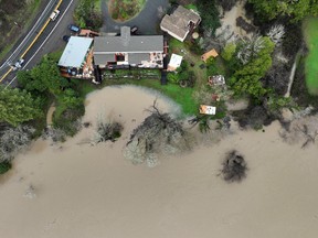 Floodwater from the Russian River approaches homes following a chain of winter storms, in Guerneville, California, January 15, 2023.